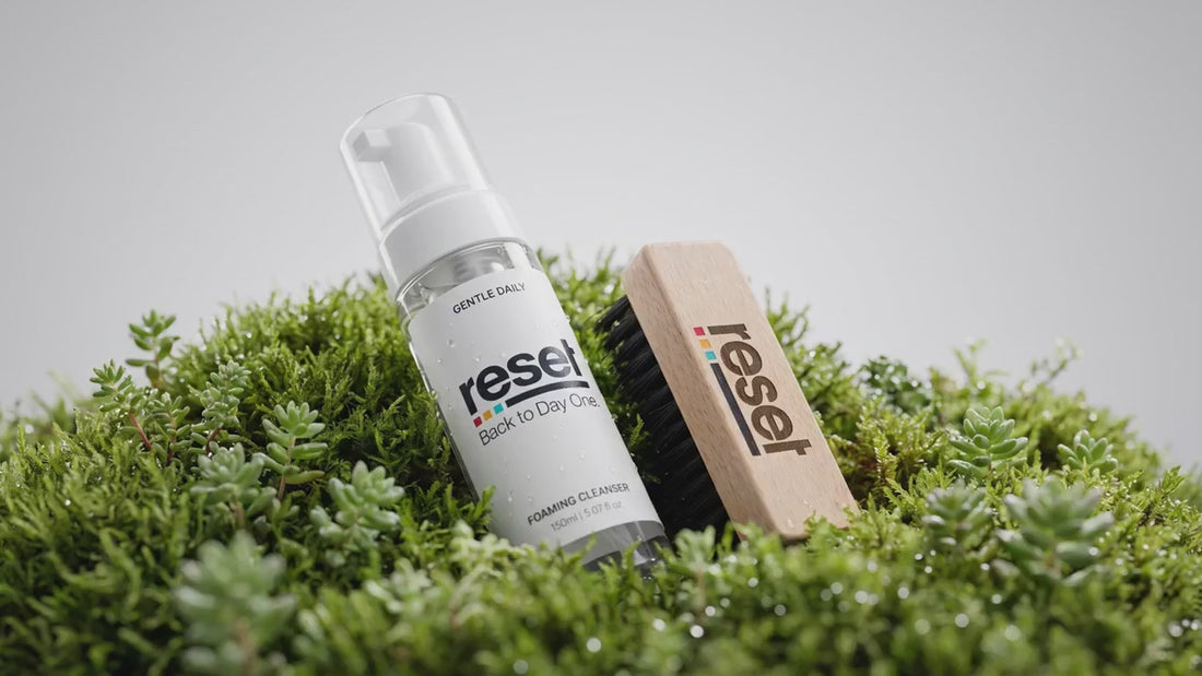 RESET shoe care — foam, brush, towel and a fresh clean sneaker in fresh green moss